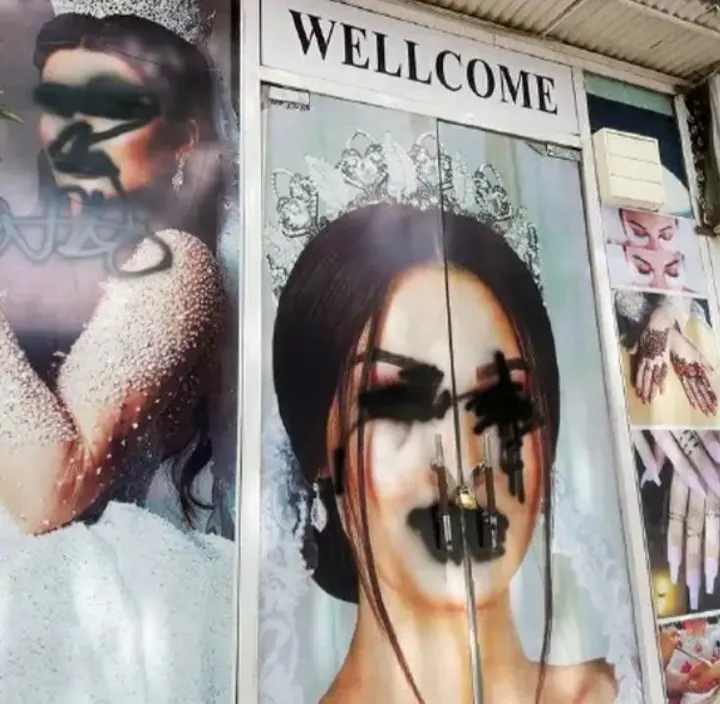 graffiti on posters of afghan women